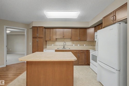 #215 4450 Mccrae Av Nw, Edmonton, AB - Indoor Photo Showing Kitchen With Double Sink