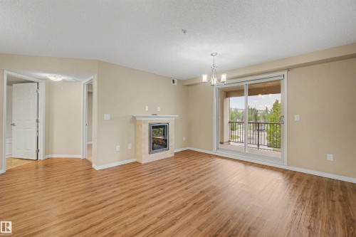 #215 4450 Mccrae Av Nw, Edmonton, AB - Indoor Photo Showing Living Room With Fireplace