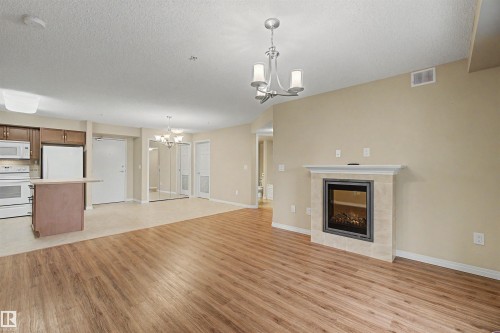 #215 4450 Mccrae Av Nw, Edmonton, AB - Indoor With Fireplace