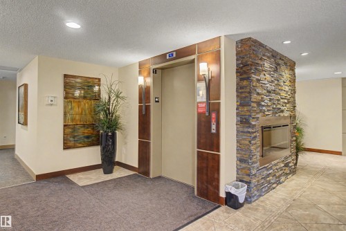 #215 4450 Mccrae Av Nw, Edmonton, AB - Indoor Photo Showing Other Room With Fireplace