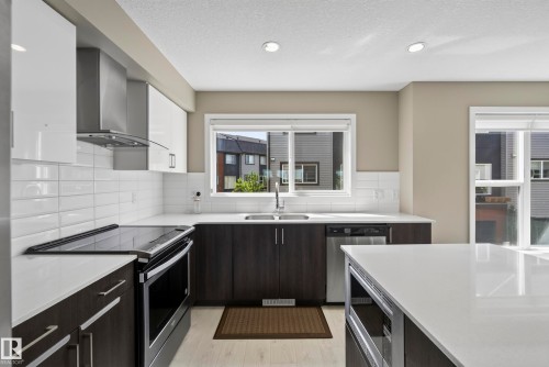 #10 1075 Rosenthal Bv Nw, Edmonton, AB - Indoor Photo Showing Kitchen With Stainless Steel Kitchen With Double Sink With Upgraded Kitchen