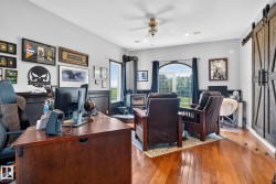 Hardwood flooring throughout this room featuring a ceiling fan and recessed lighting - 
