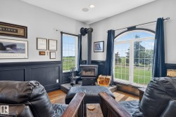 Room featuring a central wood-burning stove with a stone hearth - 