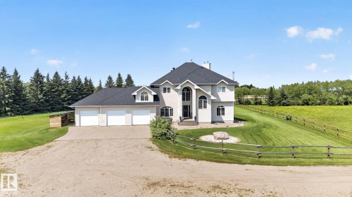 Spacious property featuring a light-toned exterior with multiple gables and a dark roof - 50336 Range Road 280, Rural Leduc County, AB - Outdoor