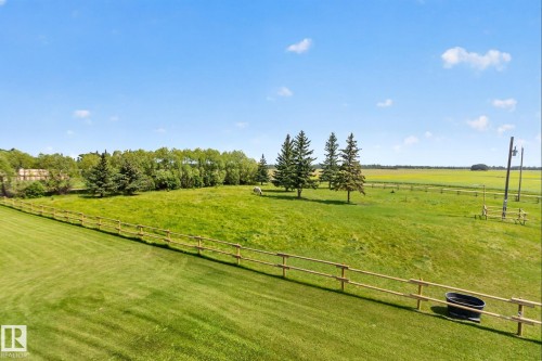 Expansive fenced acreage featuring a combination of open green spaces and mature trees - 50336 Range Road 280, Rural Leduc County, AB - Outdoor With View