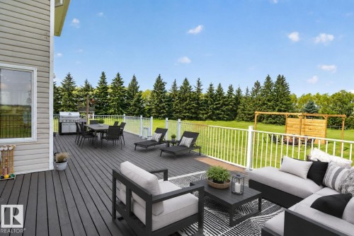 Spacious composite deck featuring white railings, providing ample room for outdoor dining and lounge areas - 50336 Range Road 280, Rural Leduc County, AB - Outdoor With Deck Patio Veranda With Exterior