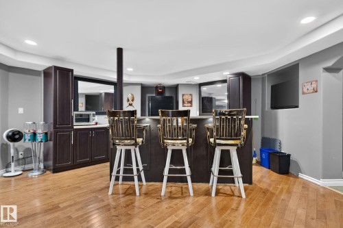 Entertainment space featuring a built-in bar with dark wood-finish cabinetry and a light-toned countertop - 50336 Range Road 280, Rural Leduc County, AB - Indoor