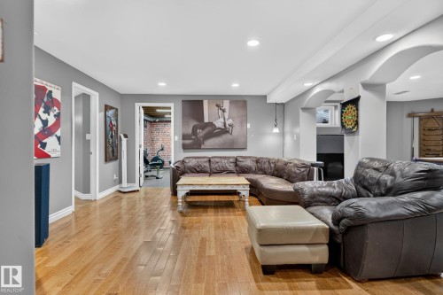 Spacious recreation room featuring wood-finish flooring, recessed lighting, and a custom bar area - 50336 Range Road 280, Rural Leduc County, AB - Indoor Photo Showing Living Room