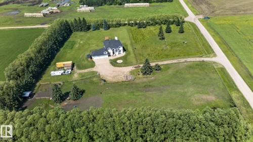 Spacious property featuring a large residence with an attached garage, surrounded by expansive green lawns - 50336 Range Road 280, Rural Leduc County, AB - Outdoor With View