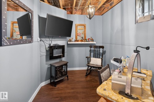 Finished basement space featuring wood-finish flooring and light gray paneling - 50336 Range Road 280, Rural Leduc County, AB - Indoor Photo Showing Other Room