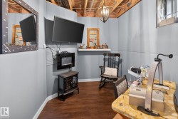 Finished basement space featuring wood-finish flooring and light gray paneling - 