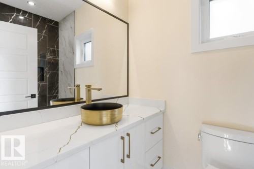 Bathroom 1 - Main Floor - 4 Piece - Modern vanity featuring a gold vessel sink and matching faucet - 10323 79 Street Nw, Edmonton, AB - Indoor Photo Showing Bathroom