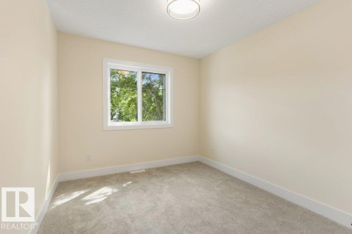 Bedroom 3 - Neutral wall color with white trim and a flush-mount ceiling light - 10323 79 Street Nw, Edmonton, AB - Indoor Photo Showing Other Room