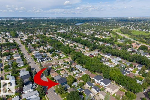 Aerial perspective of a residential street with mature trees and a distant river - 10323 79 Street Nw, Edmonton, AB - Outdoor With View