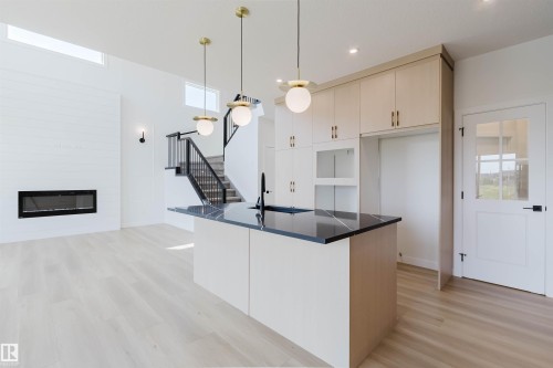 3327 Chernowski Way Sw, Edmonton, AB - Indoor Photo Showing Kitchen With Fireplace