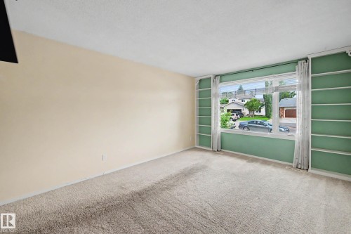 Living area featuring light-toned carpeting and neutral wall paint - 10032 173 Avenue Nw, Edmonton, AB - Indoor Photo Showing Other Room