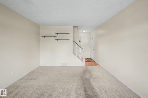 Inviting interior space featuring light-toned walls and neutral carpeting - 10032 173 Avenue Nw, Edmonton, AB - Indoor Photo Showing Other Room