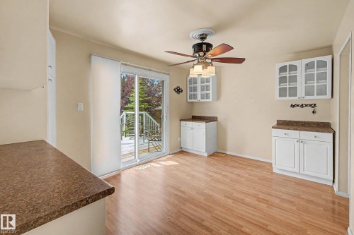 Room featuring wood-finish flooring, light-toned walls, and a ceiling fan with integrated lighting - 10032 173 Avenue Nw, Edmonton, AB - Indoor Photo Showing Other Room