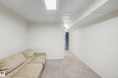 Finished basement room featuring neutral carpet flooring, clean white walls, and recessed ceiling lighting - 10032 173 Avenue Nw, Edmonton, AB - Indoor