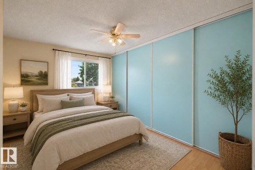 Serene primary bedroom featuring soft blue built-in wall paneling, warm wood-finish flooring, and a ceiling fan with integrated lighting - 10032 173 Avenue Nw, Edmonton, AB - Indoor Photo Showing Bedroom