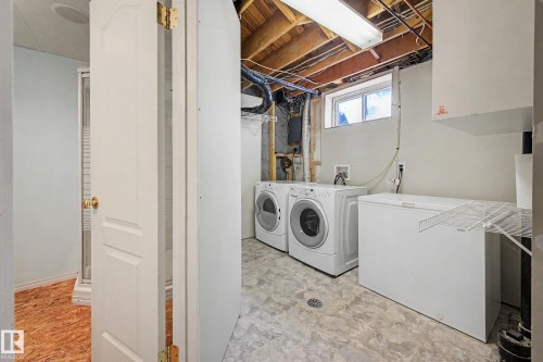 Laundry area featuring a pair of front-loading appliances, a utility sink, and a high-level window - 10032 173 Avenue Nw, Edmonton, AB - Indoor Photo Showing Laundry Room
