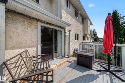 Outdoor deck with painted wood flooring, white railing, and stucco exterior - 10032 173 Avenue Nw, Edmonton, AB - Outdoor With Exterior
