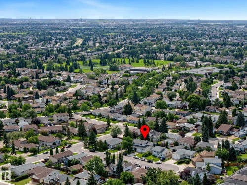 Aerial perspective showcasing a residential neighborhood with numerous single-family homes, mature trees, and green spaces - 10032 173 Avenue Nw, Edmonton, AB - Outdoor With View