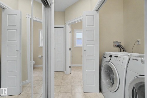 Laundry area with tile flooring and neutral wall tones - 6016 10 Avenue Sw, Edmonton, AB - Indoor Photo Showing Laundry Room