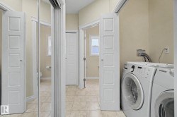 Laundry area with tile flooring and neutral wall tones - 