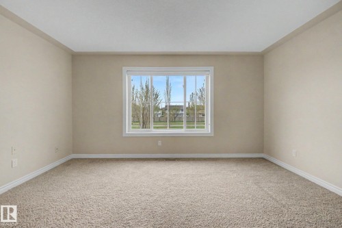 Spacious room featuring neutral carpeting and light-colored walls - 6016 10 Avenue Sw, Edmonton, AB - Indoor Photo Showing Other Room