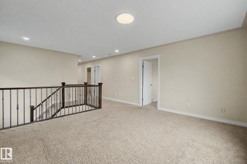 Carpeted landing with white walls and baseboards - 6016 10 Avenue Sw, Edmonton, AB - Indoor Photo Showing Other Room