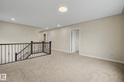 Carpeted landing with white walls and baseboards - 
