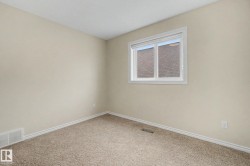 Neutral-toned walls complement plush carpeting and white baseboards - 
