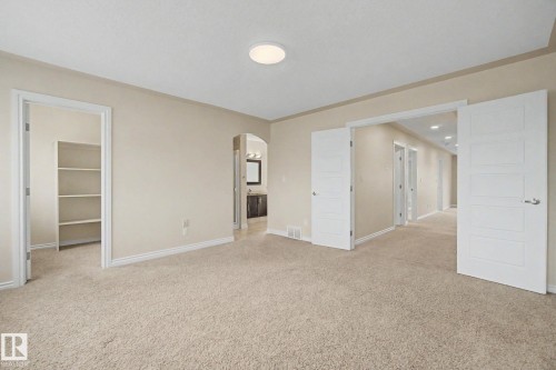 Carpeted room featuring neutral wall tones, white trim, and a flush-mount ceiling light - 6016 10 Avenue Sw, Edmonton, AB - Indoor Photo Showing Other Room