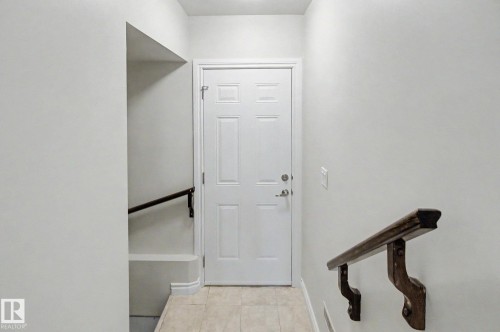 White interior door with panel detailing - 6016 10 Avenue Sw, Edmonton, AB - Indoor Photo Showing Other Room