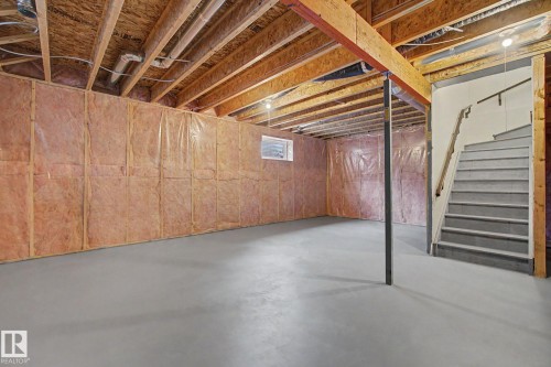 Unfinished basement featuring exposed wood joists, insulated perimeter walls, and a concrete floor - 6016 10 Avenue Sw, Edmonton, AB - Indoor Photo Showing Basement