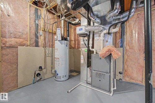 Mechanical room featuring a water heater, furnace, and exposed ductwork - 6016 10 Avenue Sw, Edmonton, AB - Indoor Photo Showing Basement
