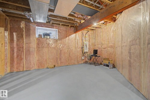 Unfinished basement featuring exposed wood joists, insulated walls, and a concrete floor - 6016 10 Avenue Sw, Edmonton, AB - Indoor Photo Showing Basement