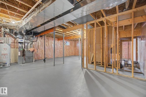 Unfinished basement with concrete flooring, exposed wood framing, exposed ductwork, and visible insulation - 6016 10 Avenue Sw, Edmonton, AB - Indoor Photo Showing Basement