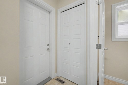 Entryway featuring a paneled door, bi-fold closet doors, and tile flooring - 6016 10 Avenue Sw, Edmonton, AB - Indoor Photo Showing Other Room