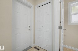 Entryway featuring a paneled door, bi-fold closet doors, and tile flooring - 