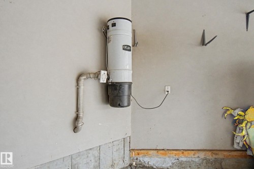 Central vacuum system installed on a painted wall - 6016 10 Avenue Sw, Edmonton, AB - Indoor