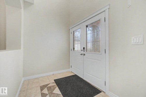 Double entry doors with decorative arched glass inserts - 6016 10 Avenue Sw, Edmonton, AB - Indoor Photo Showing Other Room
