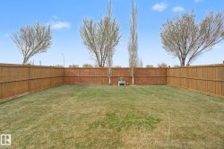 Expansive backyard featuring a natural grass lawn - 