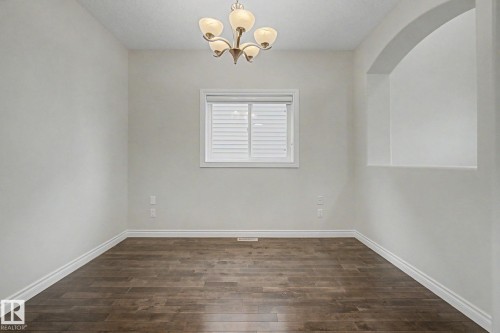 Room featuring wood-finish flooring, white baseboards, and neutral wall tones - 6016 10 Avenue Sw, Edmonton, AB - Indoor Photo Showing Other Room