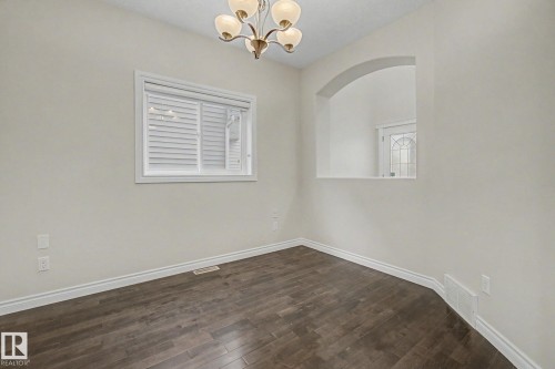 Interior room with dark wood-finish flooring, white baseboards, and light-colored walls - 6016 10 Avenue Sw, Edmonton, AB - Indoor Photo Showing Other Room