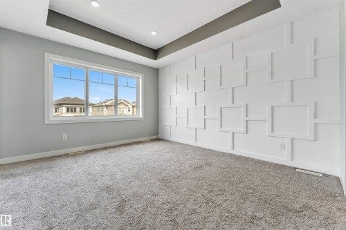 Bright interior space featuring a full wall of decorative paneling - 6075 180 Avenue Nw, Edmonton, AB - Indoor Photo Showing Other Room