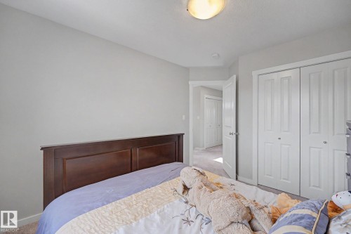 Light gray walls with white baseboards frame this room - 2314 Wonnacott Crescent Sw, Edmonton, AB - Indoor Photo Showing Bedroom