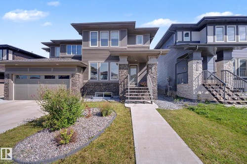 Contemporary residence featuring a multi-tone facade with stone and horizontal siding - 2314 Wonnacott Crescent Sw, Edmonton, AB - Outdoor With Facade
