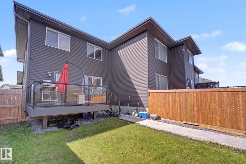 Rear elevation featuring a private deck with glass panel railing and integrated stairs - 2314 Wonnacott Crescent Sw, Edmonton, AB - Outdoor With Deck Patio Veranda
